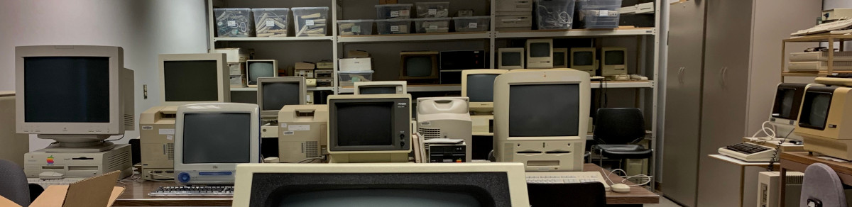 a heterogenous mix of old desktop computers, mostly beige with CRT monitors